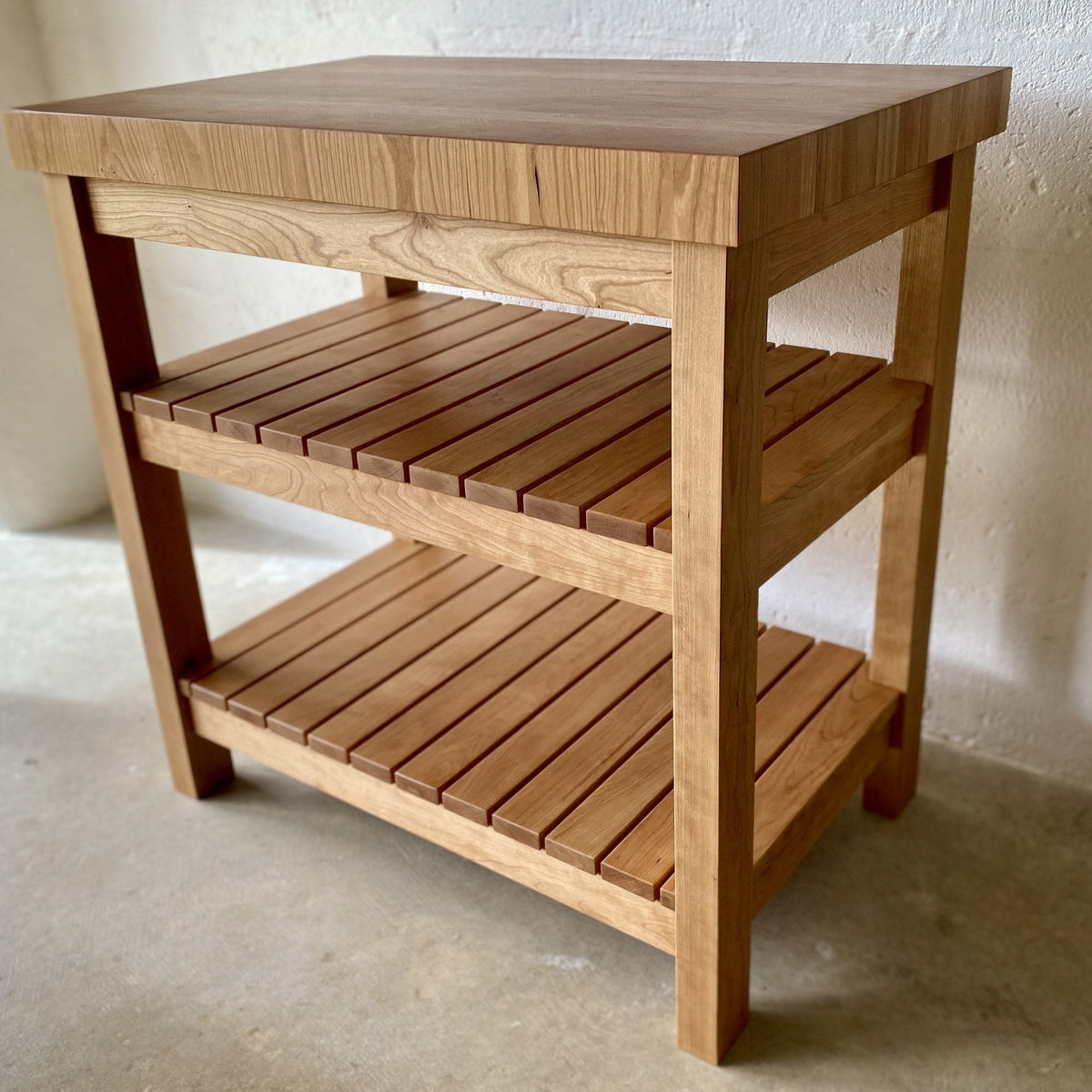 American cherry end grain butcher's island second angle showing slatted shelves and solid frame – East Wood Design