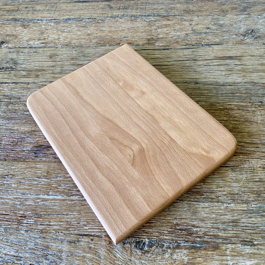 Small European beech chopping board flat lay on rustic timber surface showing pale grain – East Wood Design
