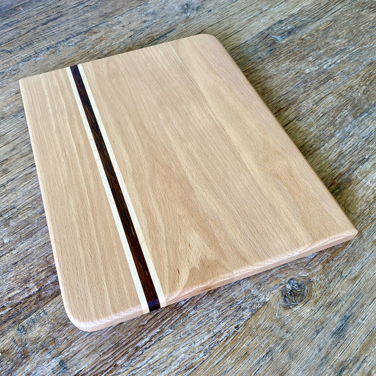 European beech chopping board with Kwila and maple stripe angled view showing inlay detail – East Wood Design
