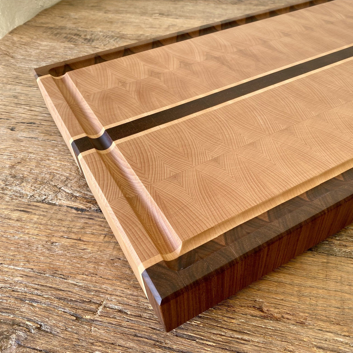 European Beech End Grain board – close-up angled view showing juice groove and maple accent inlay