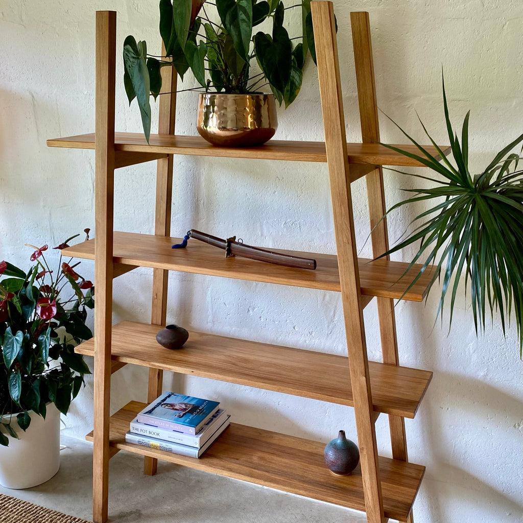 Ladder shelf stand in Pacific Rimu timber, straight-on front view showing all four shelves and leg frame detail
