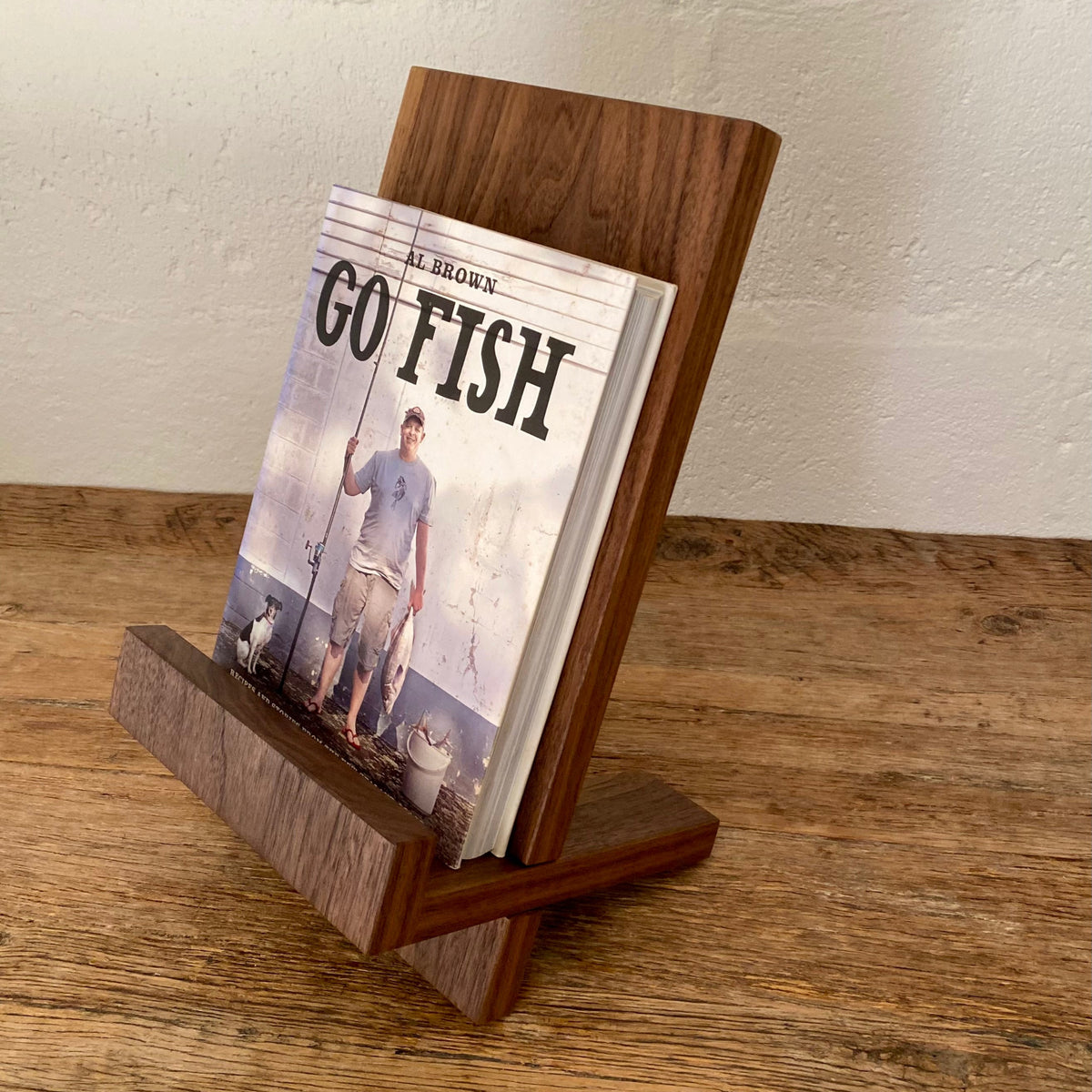 Book stand in Black Walnut holding a large cookbook, side profile view