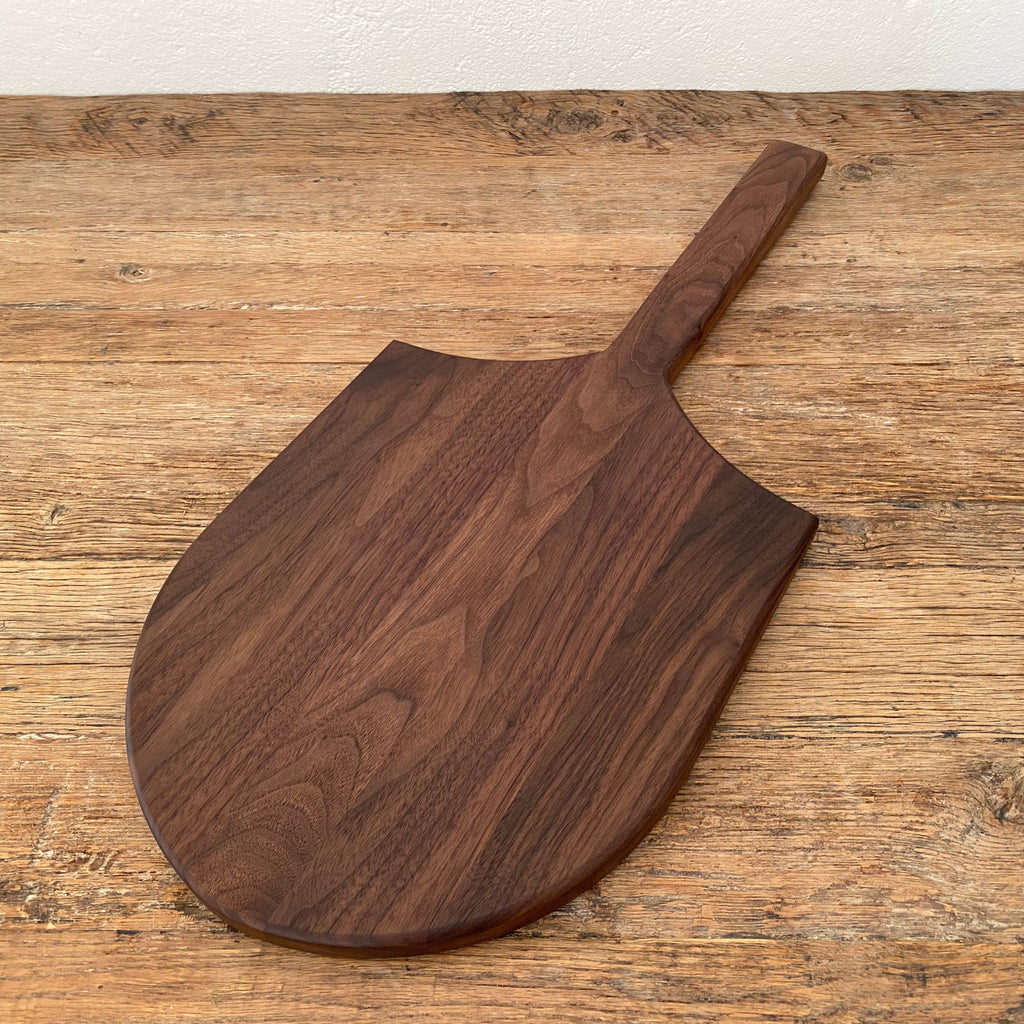 Long Tail Ray Board in American walnut – side view showing rounded board shape and handle profile