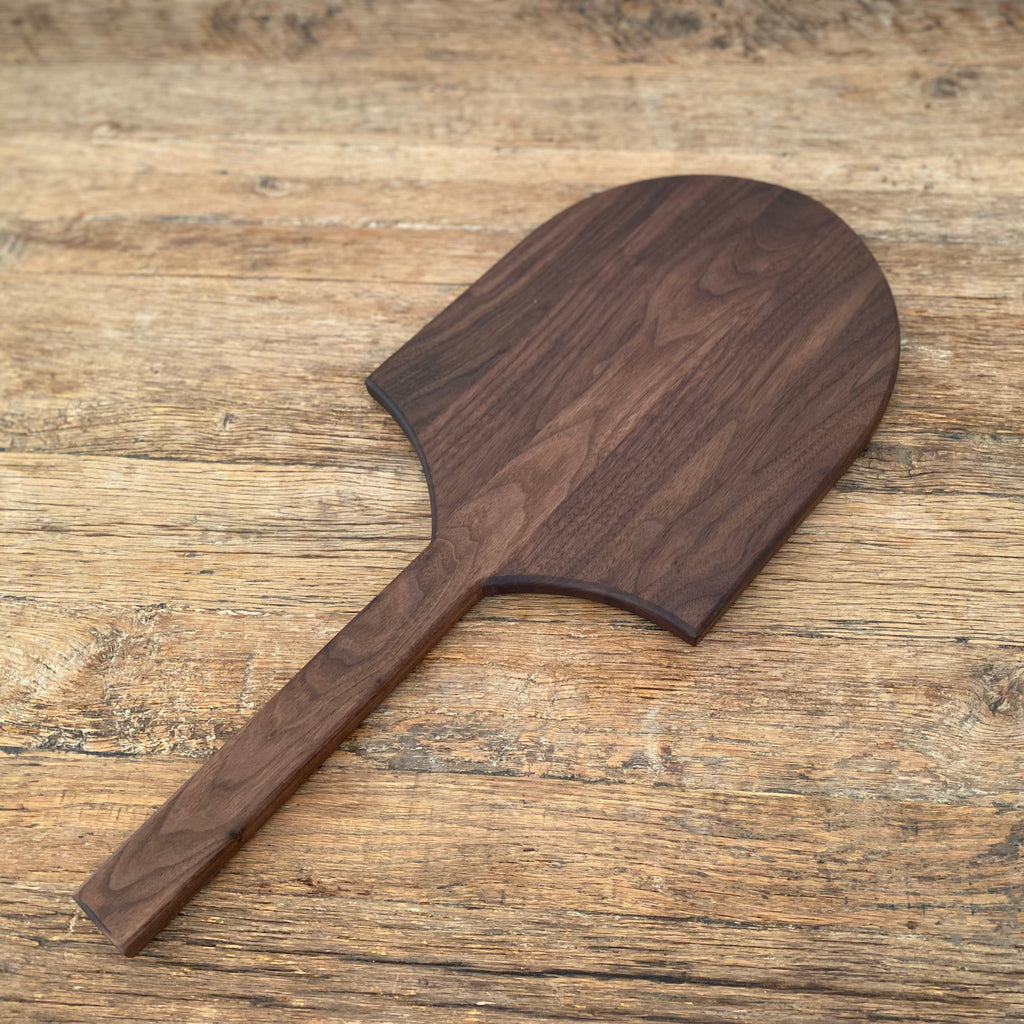 Long Tail Ray Board in American walnut – angled view on rustic timber surface showing grain detail