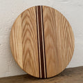 The Rounds American Ash with Kwila and Maple stripe – upright against white wall showing full face