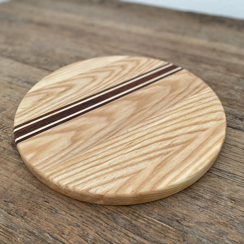 The Rounds American Ash with Kwila and Maple stripe – angled top-down view on rustic timber surface