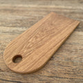 White oak arc platter with finger hole, teardrop shape flat lay on rustic timber surface – East Wood Design