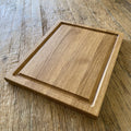 White oak carving board with routed juice groove, flat lay on rustic timber surface – East Wood Design