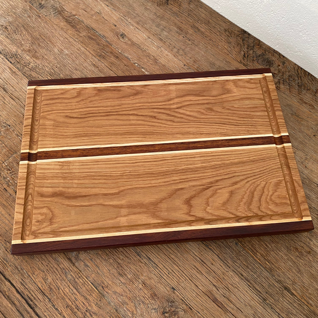 The Carver Grande chopping board with juice groove in White Oak, Kwila and Maple – angled view showing board 