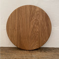 The Round White Oak serving board – upright against white wall showing grain detail