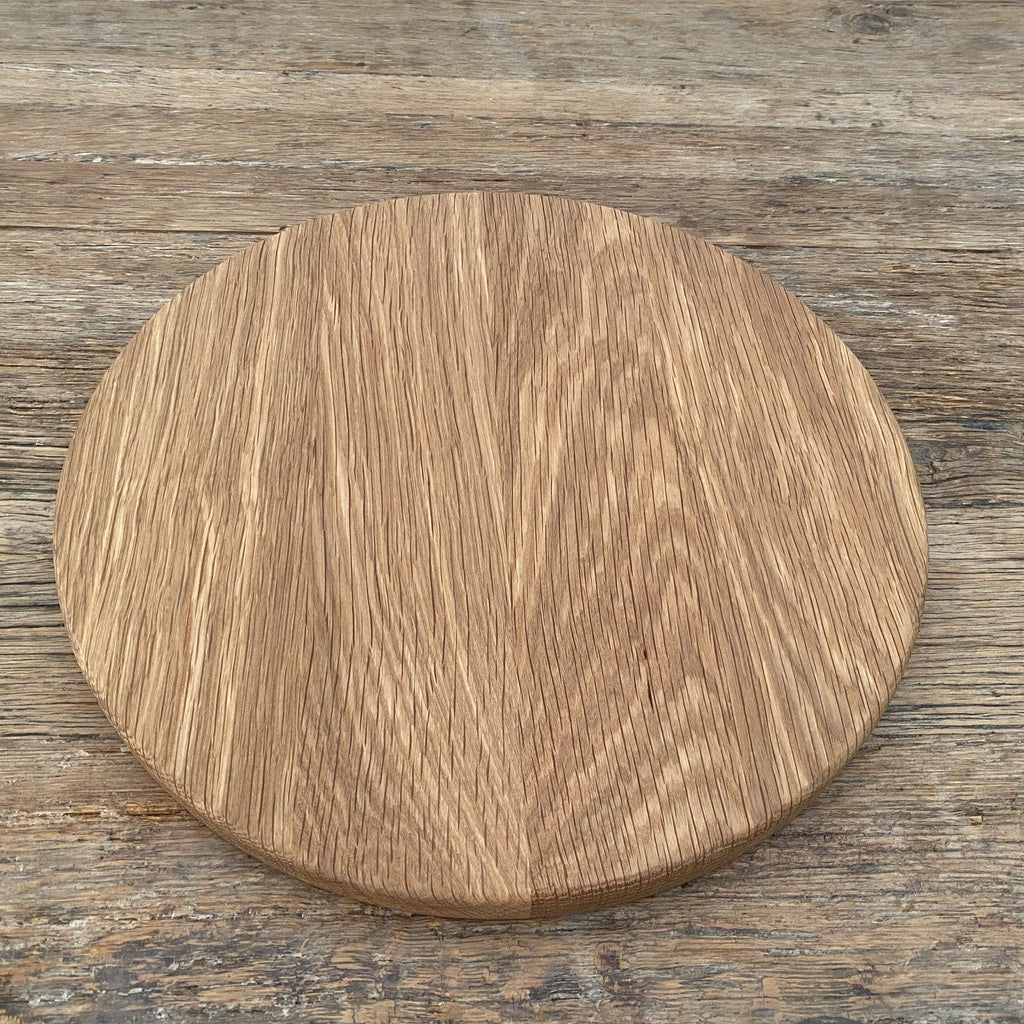 The Round White Oak serving board – flat lay top-down view on rustic timber surface